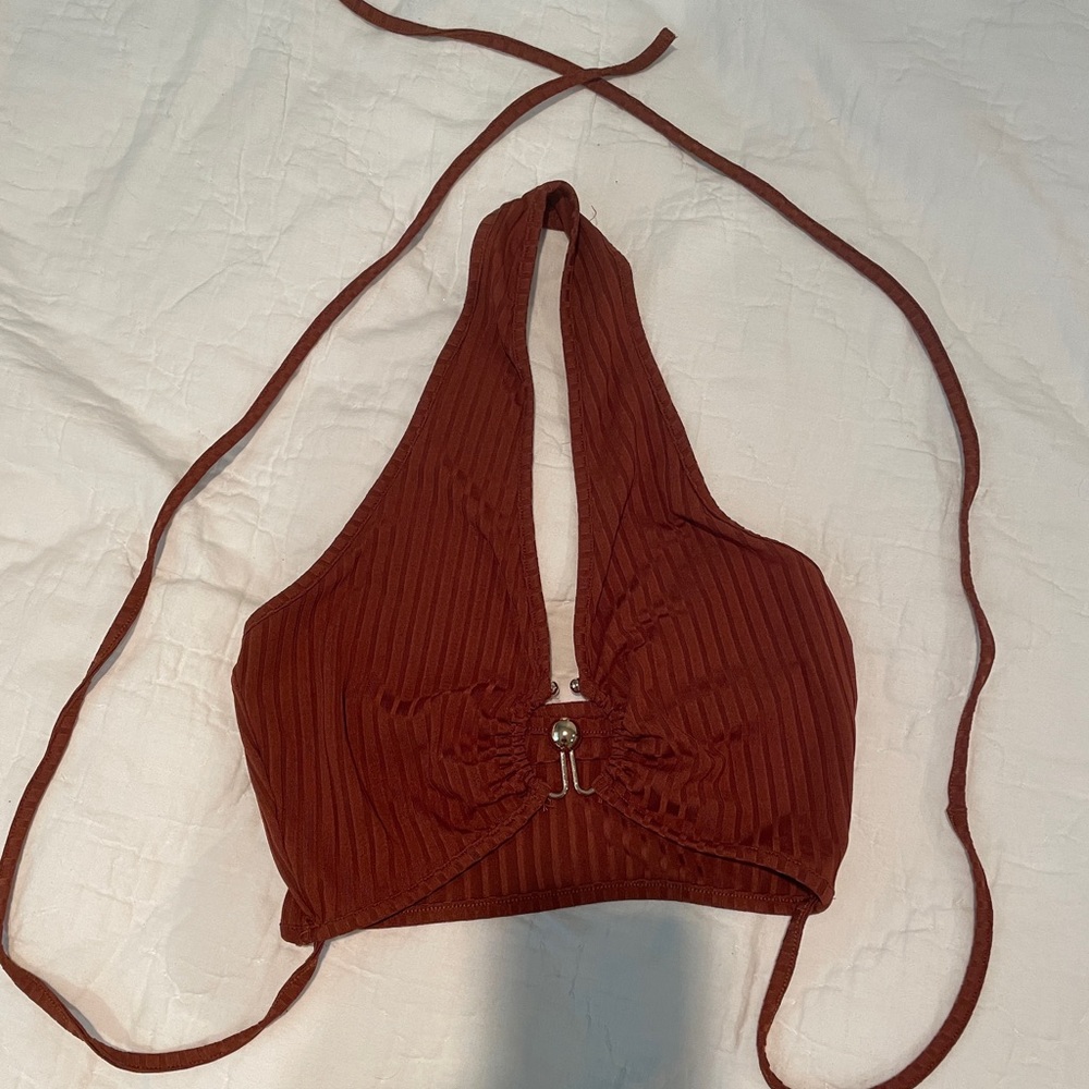 brown crop top with gold hoop in the front